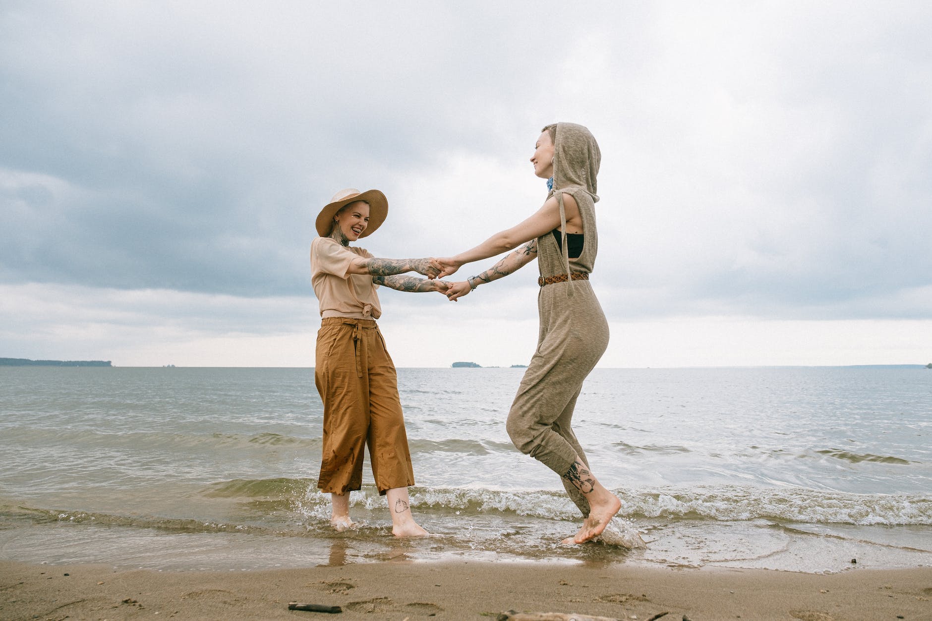 photo of women standing on beach